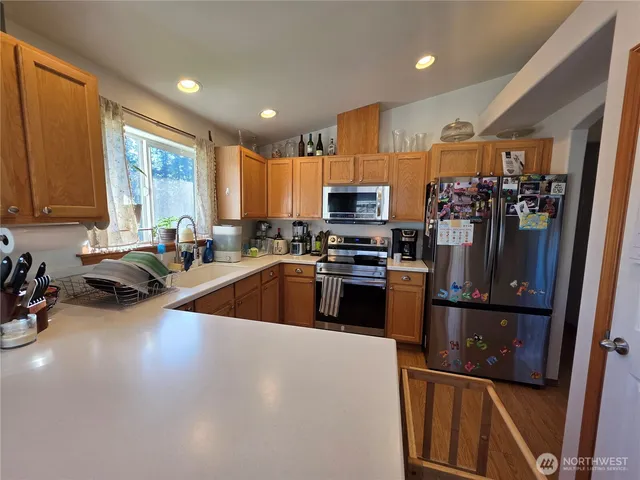 a kitchen with sink a refrigerator and cabinets