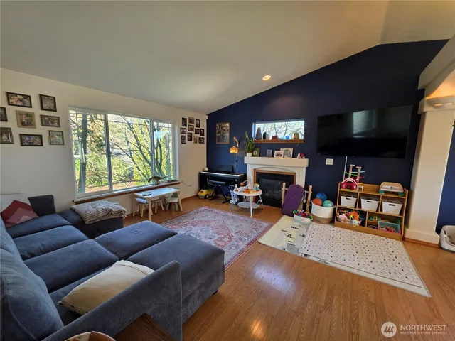 a living room with furniture a large window and a flat screen tv
