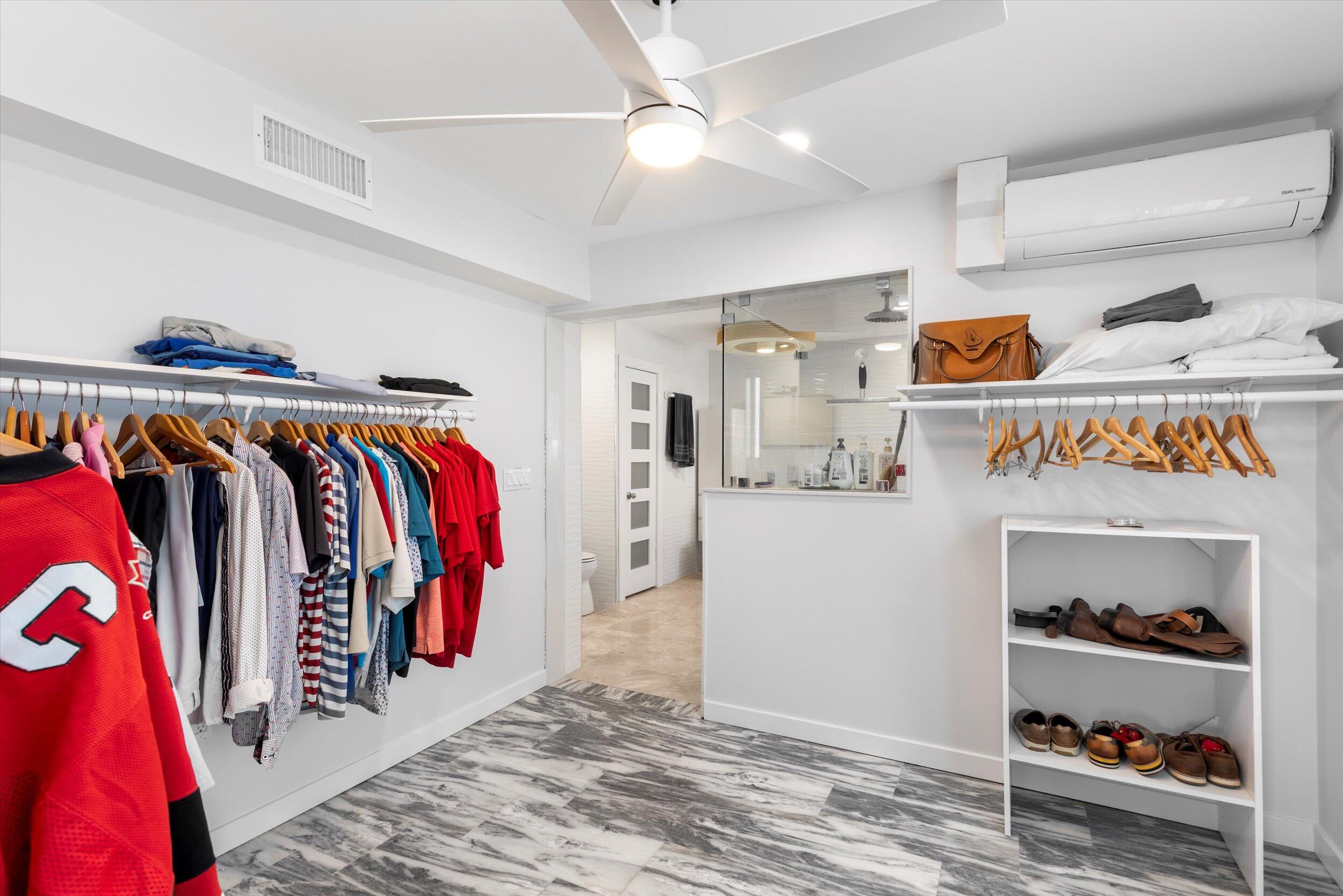2924 Riviera Drive Key West, FL 33040 - Photo 14 of 43 a view of walk in closet with clothes and shoes
