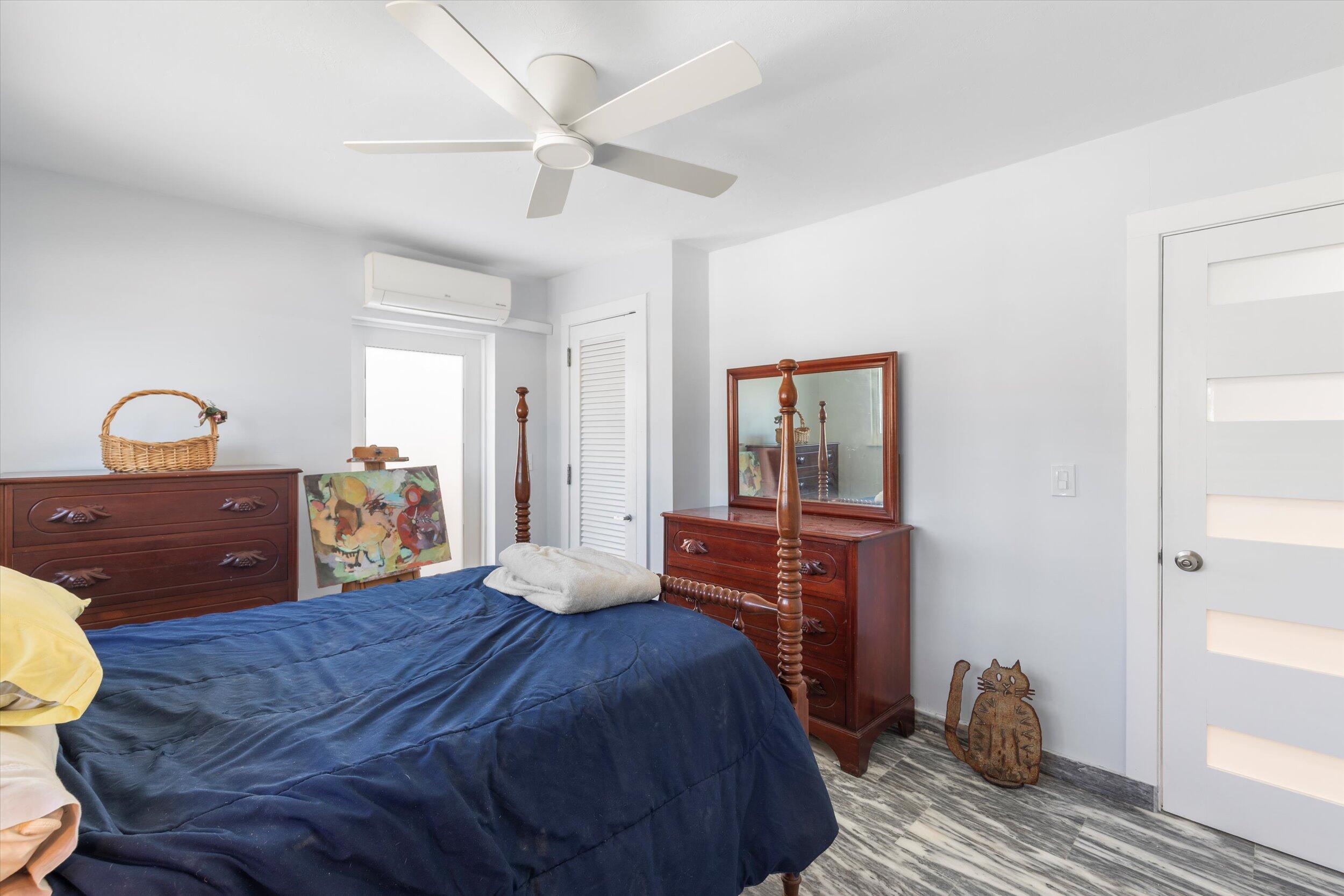 2924 Riviera Drive Key West, FL 33040 - Photo 17 of 43 a bedroom with a bed and wooden floor