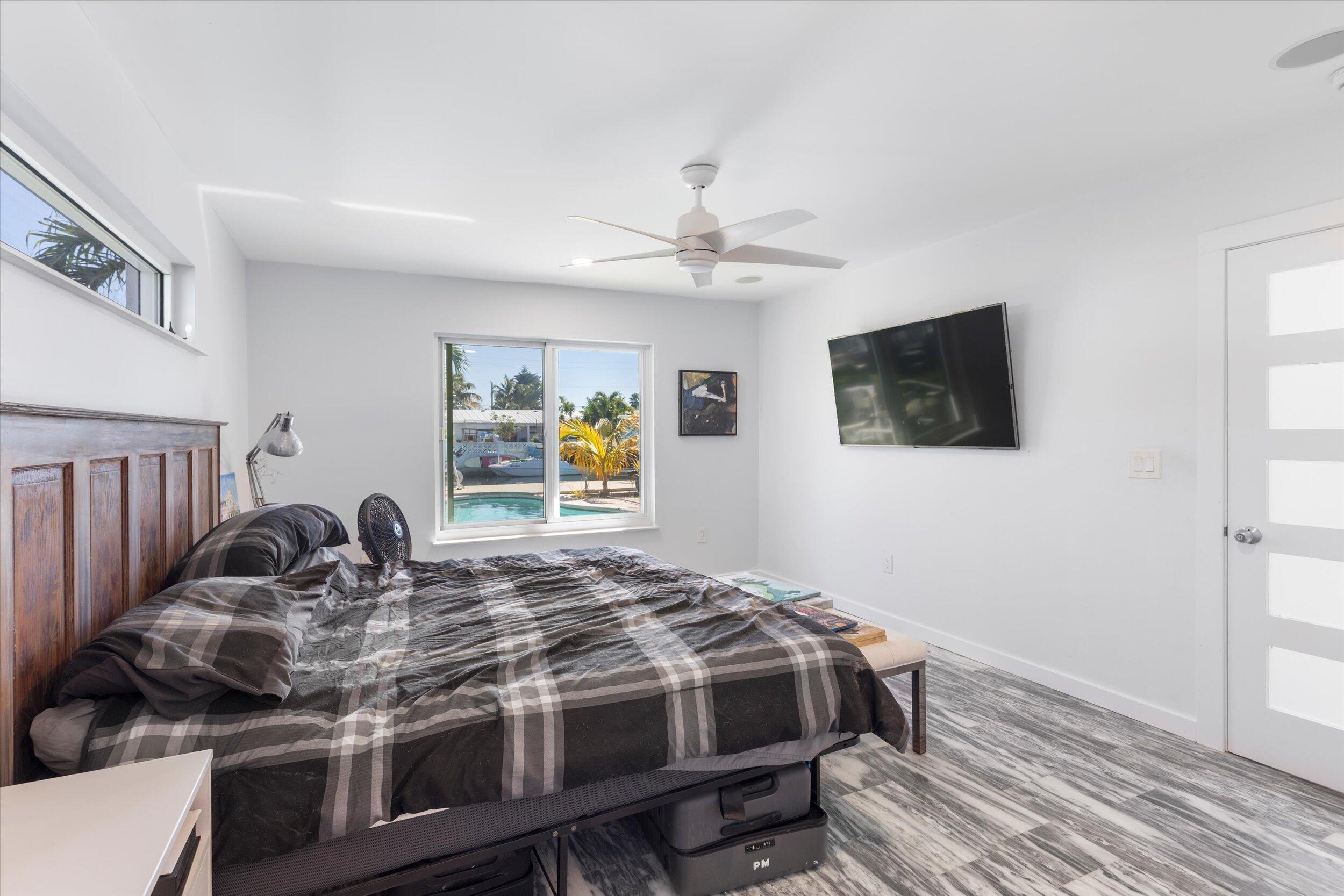 2924 Riviera Drive Key West, FL 33040 - Photo 18 of 43 a bedroom with a bed and a flat screen tv