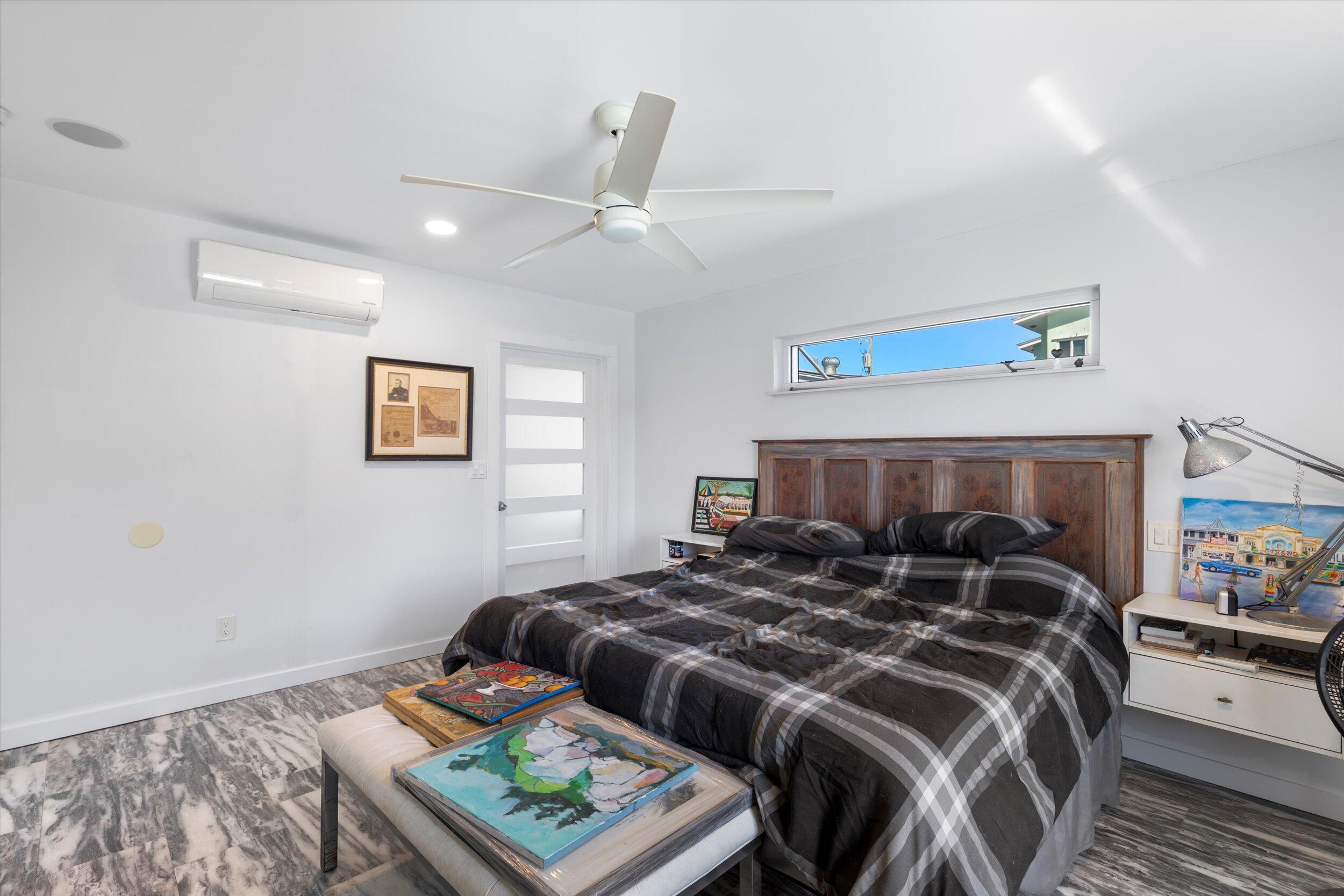 2924 Riviera Drive Key West, FL 33040 - Photo 20 of 43 a bedroom with a bed and wooden floor