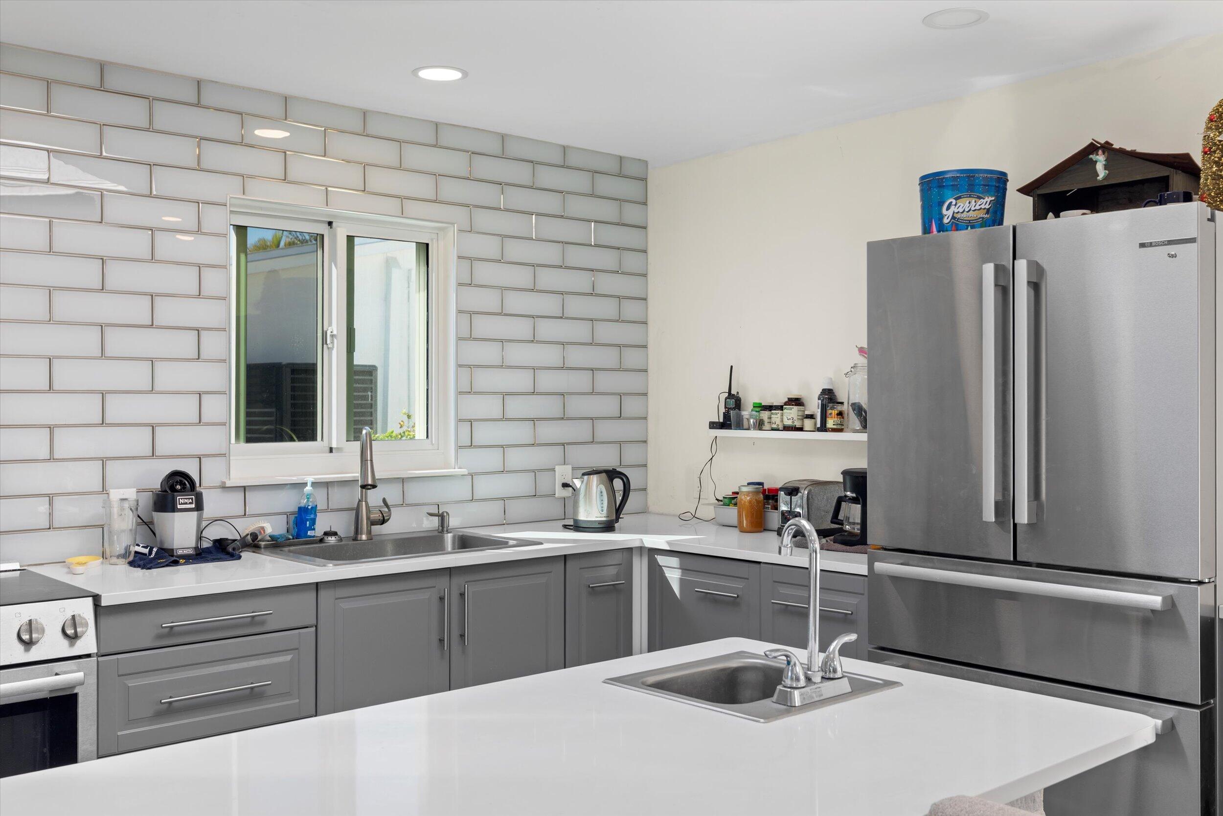 2924 Riviera Drive Key West, FL 33040 - Photo 28 of 43 a kitchen with stainless steel appliances a sink stove and refrigerator