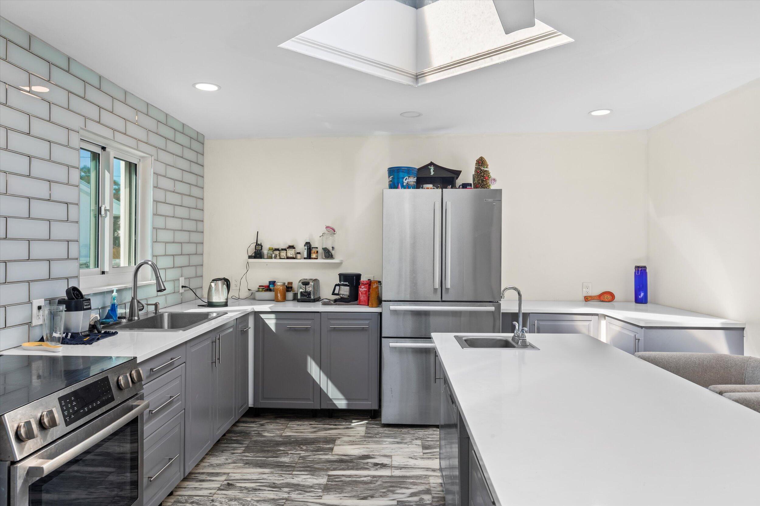 2924 Riviera Drive Key West, FL 33040 - Photo 29 of 43 a kitchen with a sink and cabinets