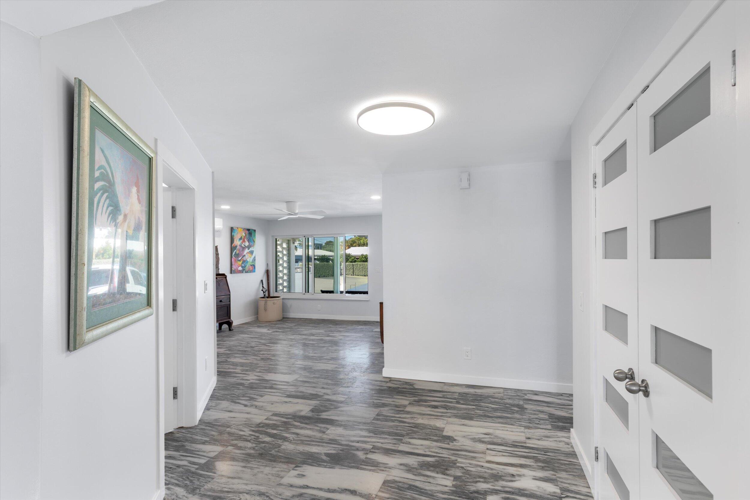 2924 Riviera Drive Key West, FL 33040 - Photo 33 of 43 a view of a hallway with wooden floor and a living room