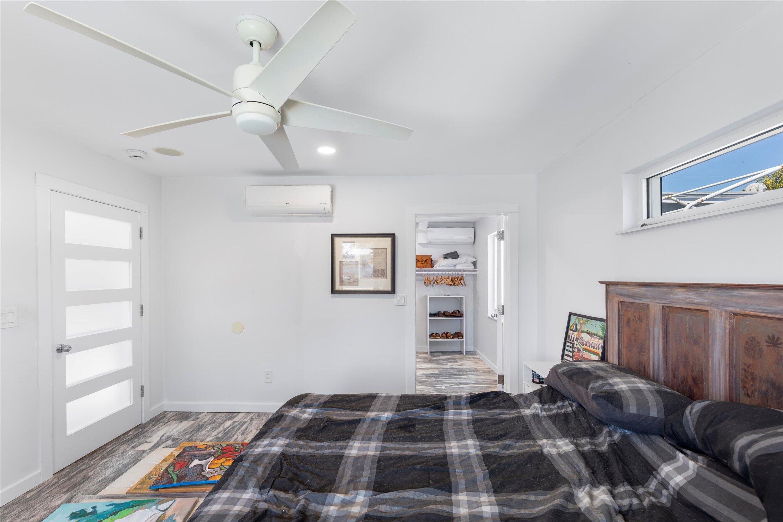 2924 Riviera Drive Key West, FL 33040 - Photo 39 of 43 a bedroom with a bed and wooden floor