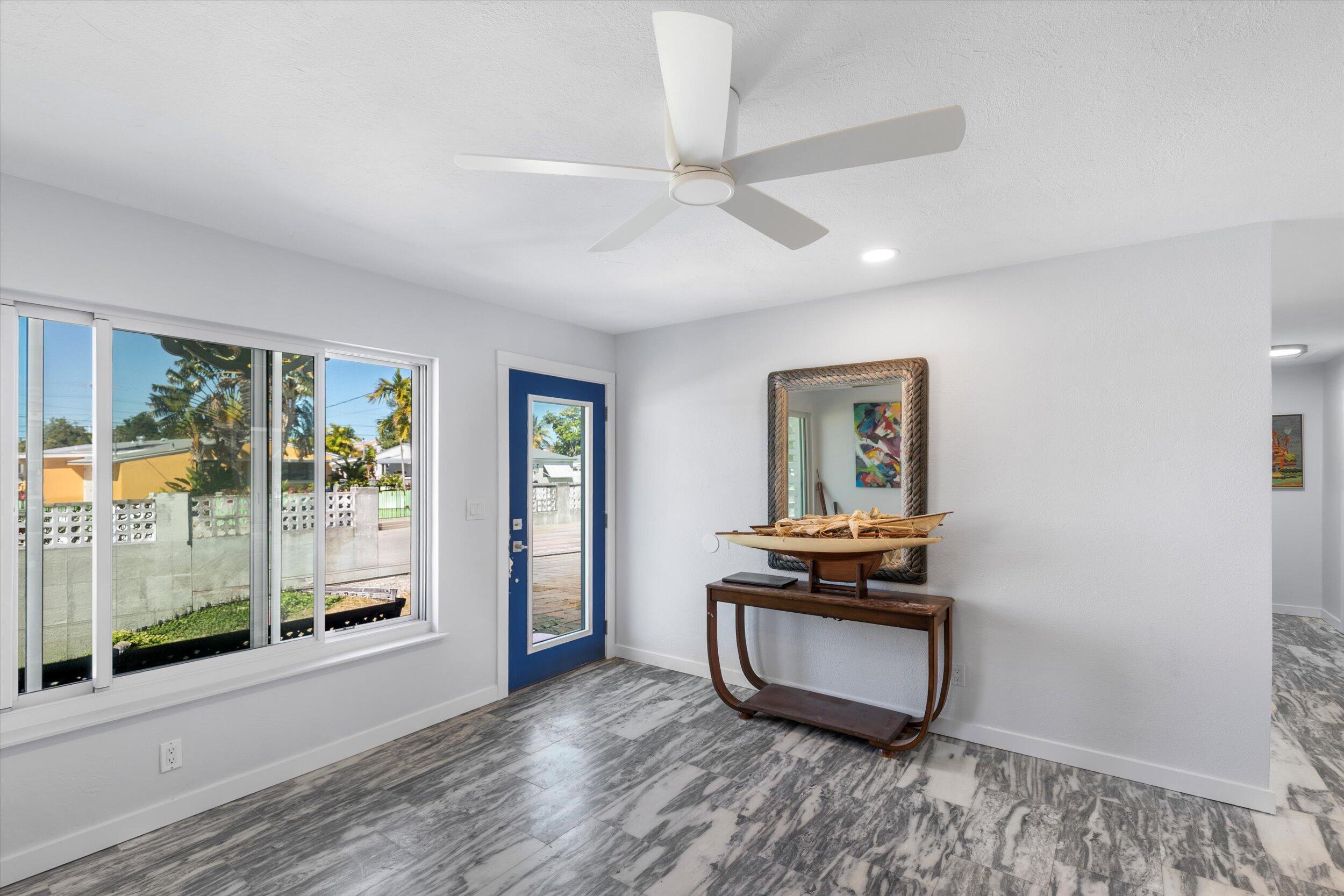 2924 Riviera Drive Key West, FL 33040 - Photo 4 of 43 a room with wooden floor and window
