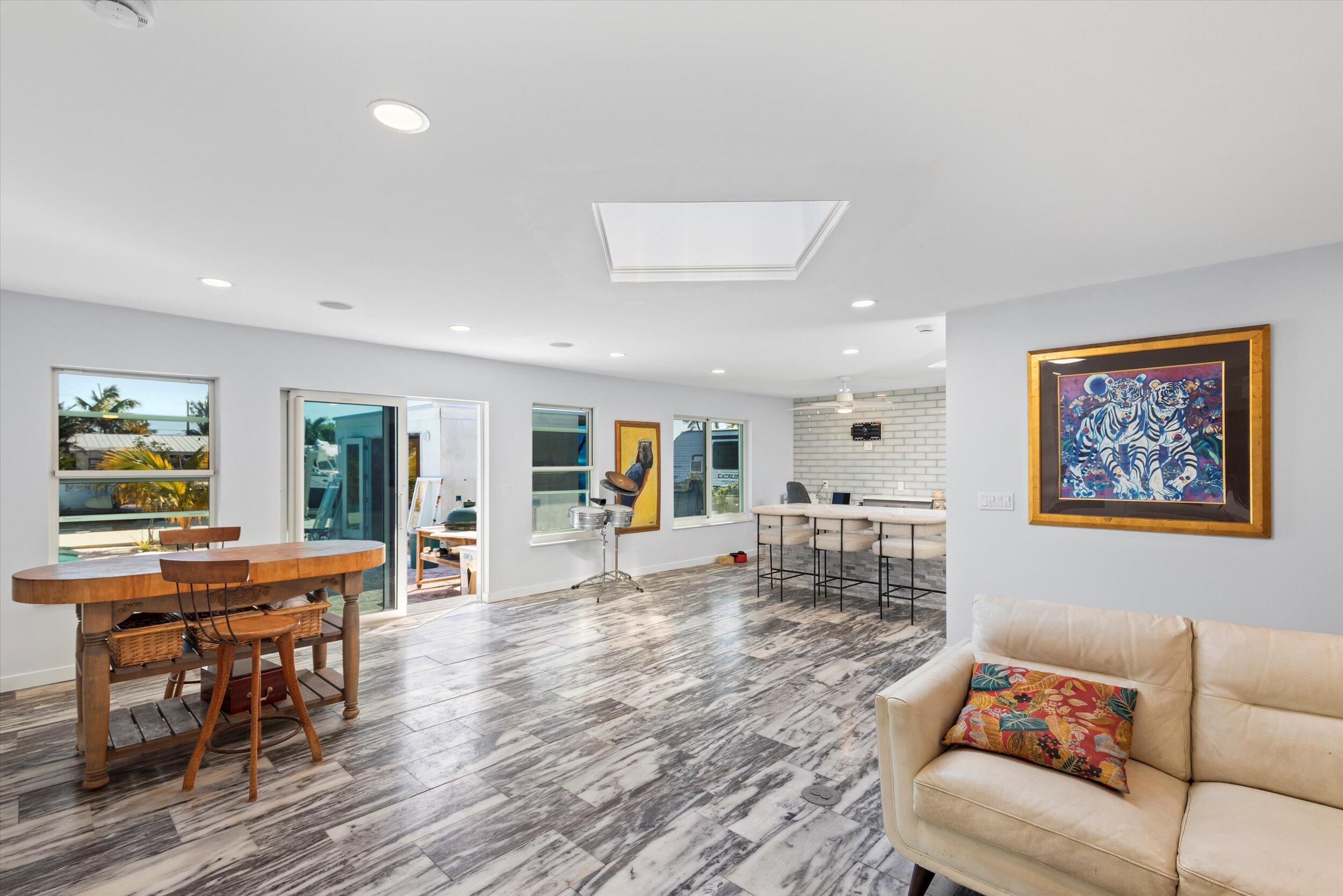 2924 Riviera Drive Key West, FL 33040 - Photo 10 of 43 a living room with furniture a wooden floor and a window