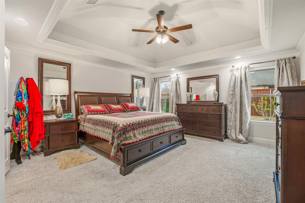 3024 Reed Court Granbury, TX 76048 - Photo 17 of 40 a bedroom with a bed and a chandelier