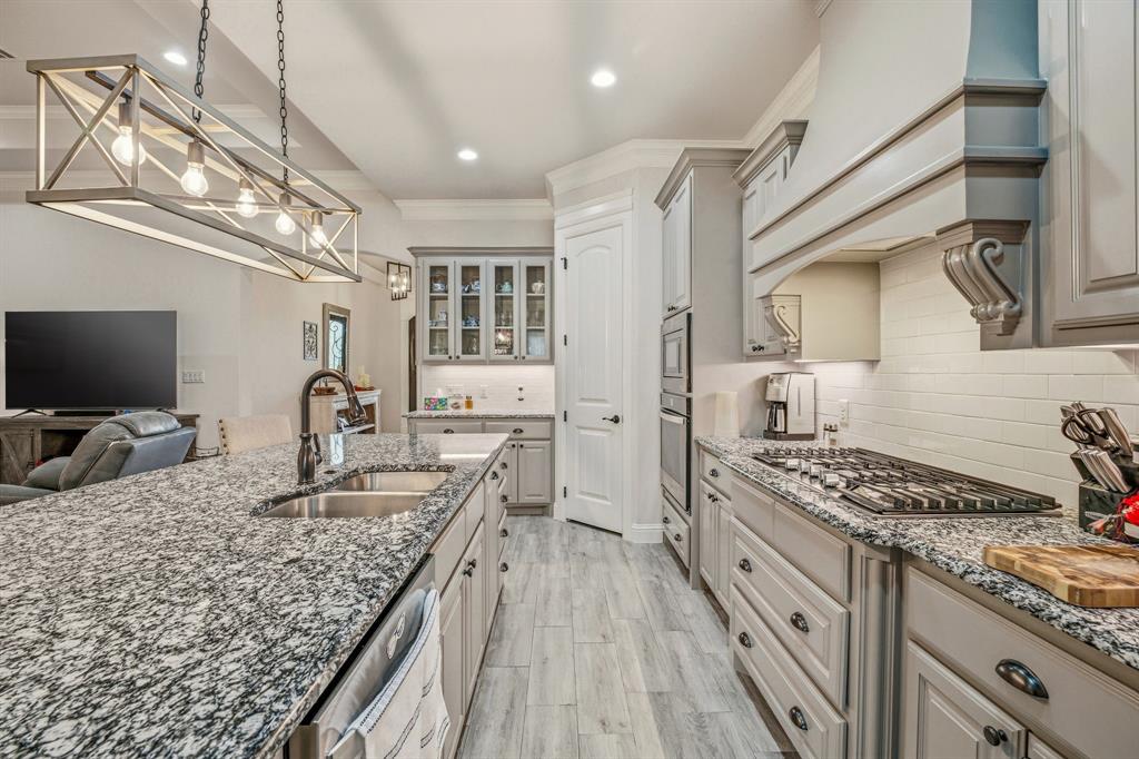 3024 Reed Court Granbury, TX 76048 - Photo 23 of 40 a kitchen with sink stove and refrigerator