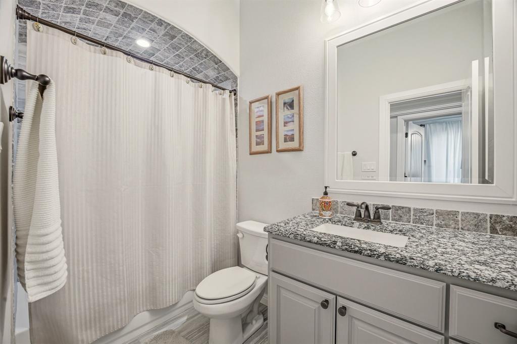 3024 Reed Court Granbury, TX 76048 - Photo 24 of 40 a bathroom with a granite countertop sink and a mirror
