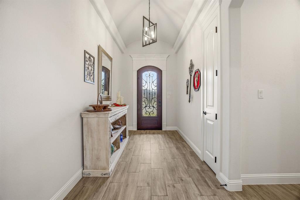 3024 Reed Court Granbury, TX 76048 - Photo 5 of 40 a view of a hallway view with wooden floor and staircase