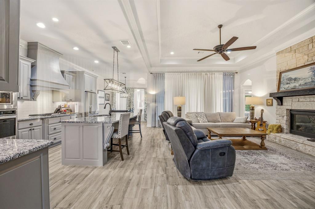 3024 Reed Court Granbury, TX 76048 - Photo 6 of 40 a living room with furniture and a wooden floor