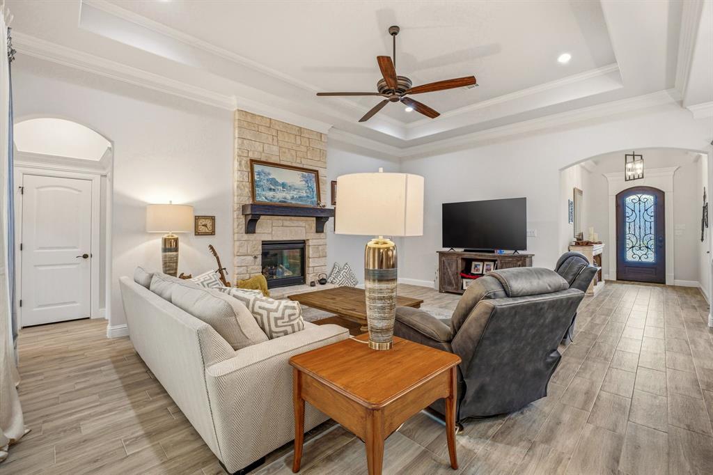 3024 Reed Court Granbury, TX 76048 - Photo 9 of 40 a living room with furniture a ceiling fan and a flat screen tv