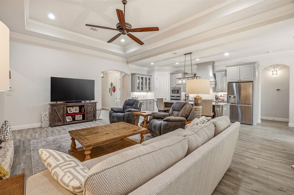 3024 Reed Court Granbury, TX 76048 - Photo 10 of 40 a living room with furniture and a flat screen tv