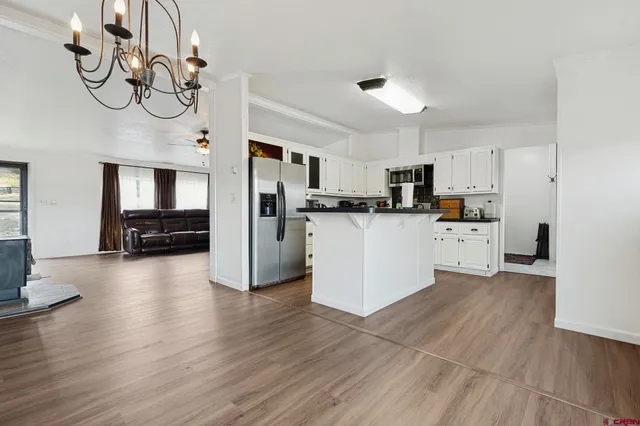 a view of a kitchen with sink and wooden floor