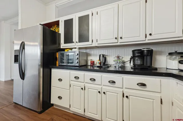 a kitchen with stainless steel appliances granite countertop a refrigerator and cabinets