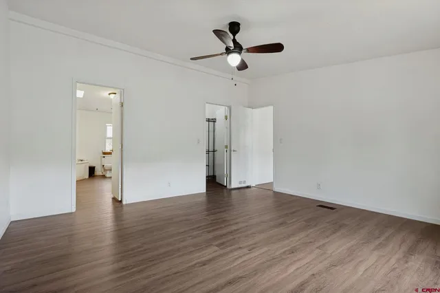 a view of an empty room and wooden floor