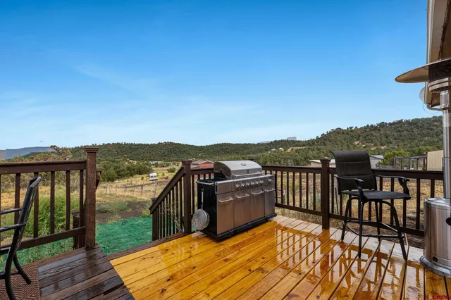 a view of a balcony with wooden floor and iron stairs