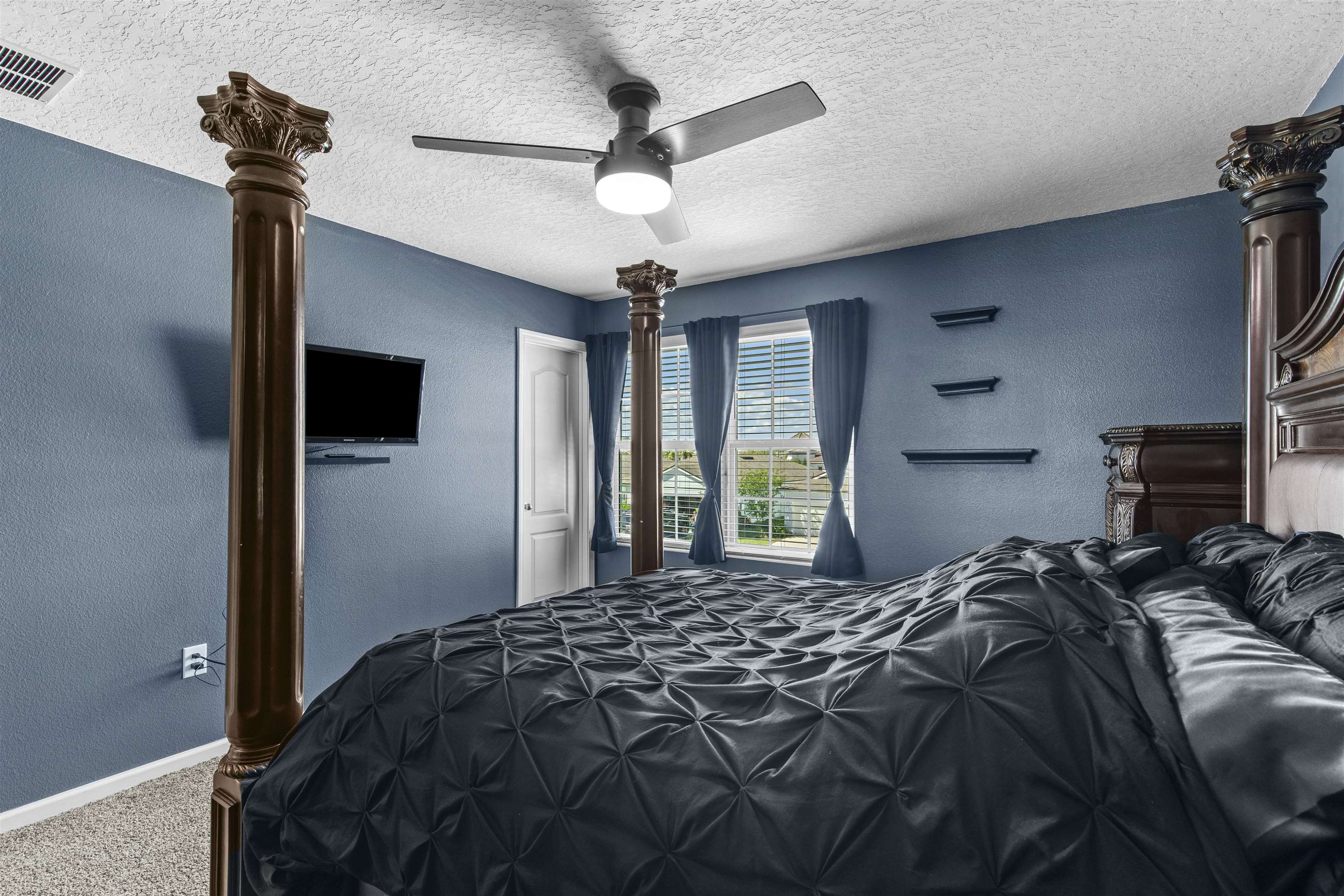 266 Caminha Road St. Augustine, FL 32084 - Photo 28 of 59 a bedroom with a bed window and a flat screen tv