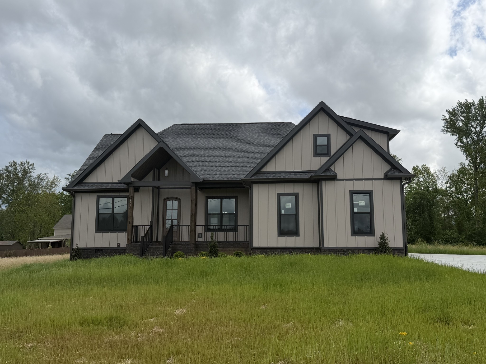 a front view of house with yard and green space
