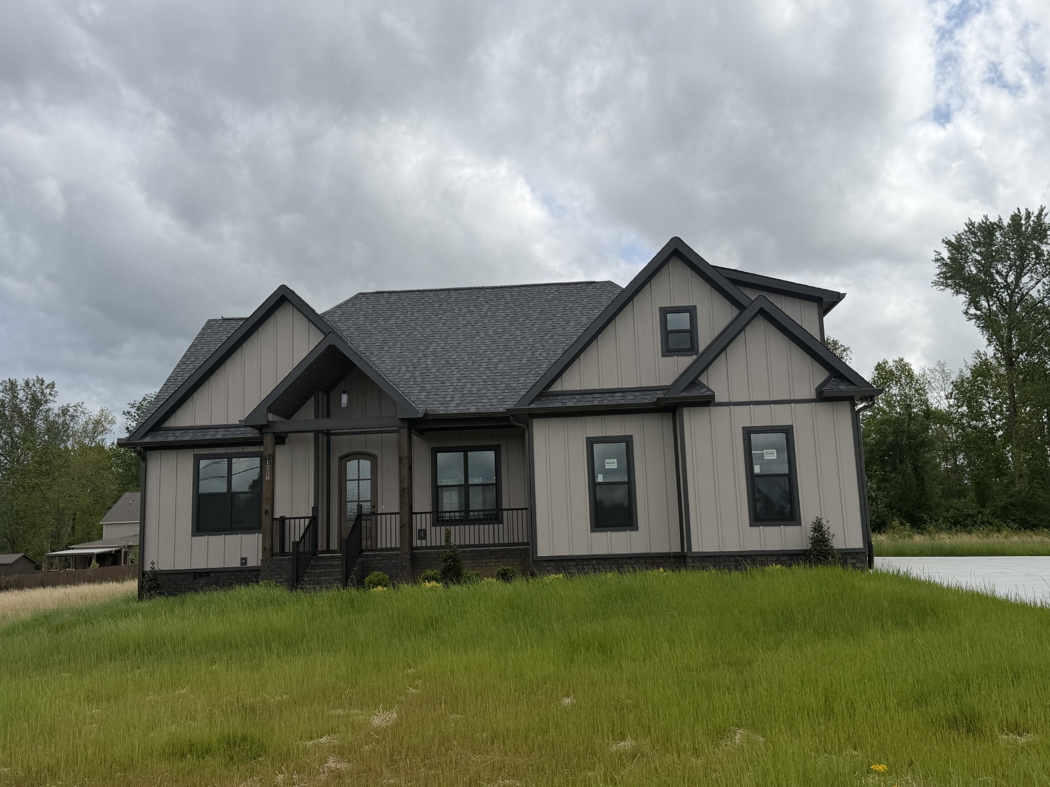 1258 Tom Grissom Road Morrison, TN 37357 - Photo 2 of 8 a front view of a house with a garden and yard