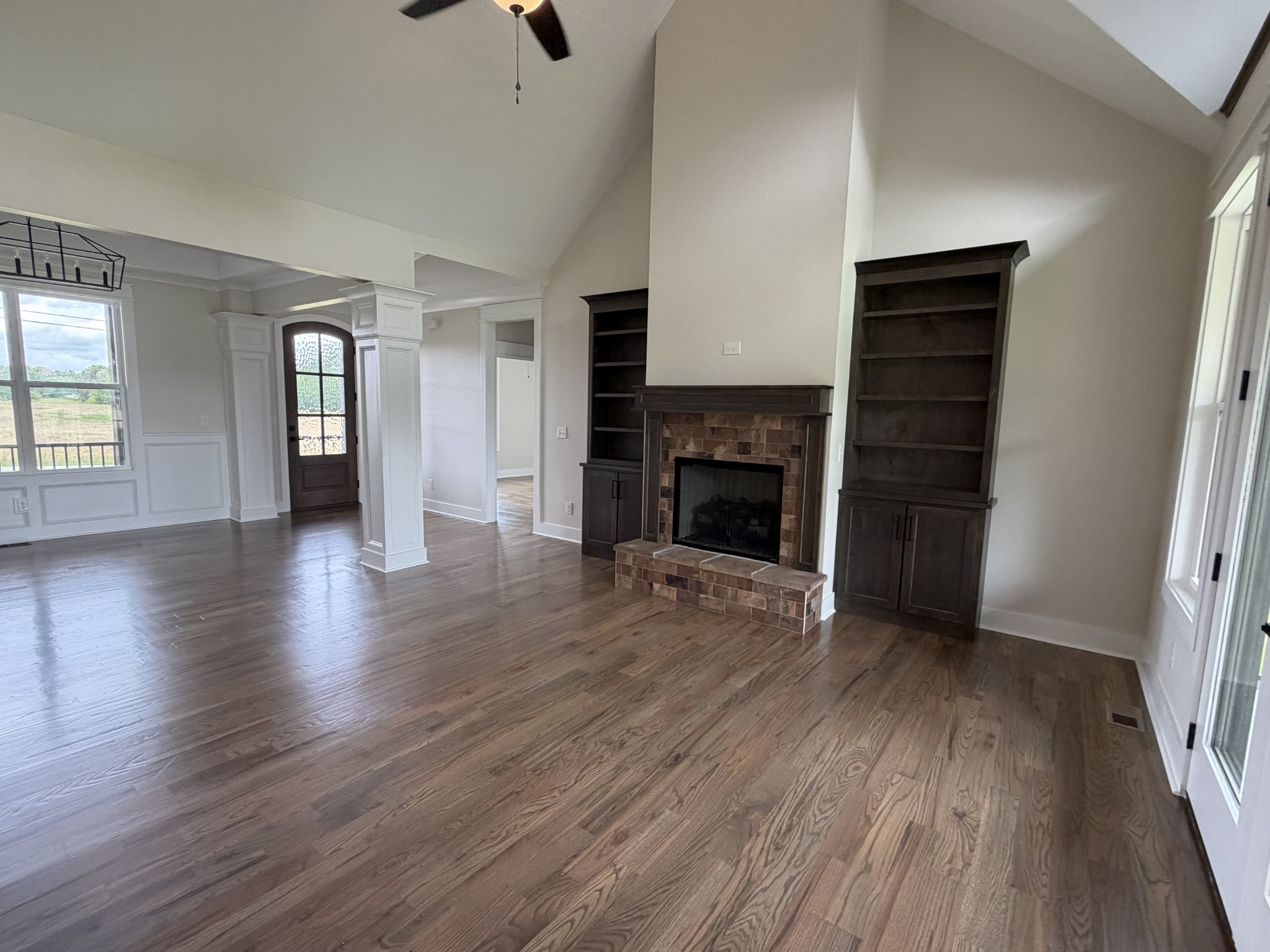 1258 Tom Grissom Road Morrison, TN 37357 - Photo 4 of 8 an empty room with wooden floor fireplace and windows