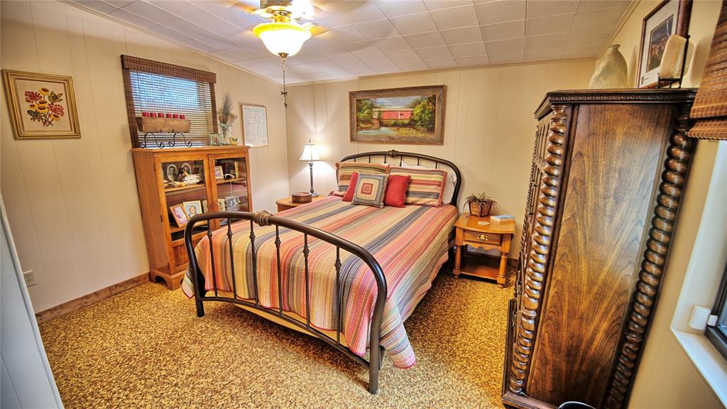 858 Ford Road Bowie, TX 76230 - Photo 12 of 40 a bedroom with furniture and a rug