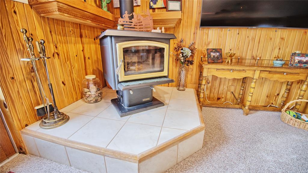 858 Ford Road Bowie, TX 76230 - Photo 13 of 40 a living room with fireplace furniture and a window