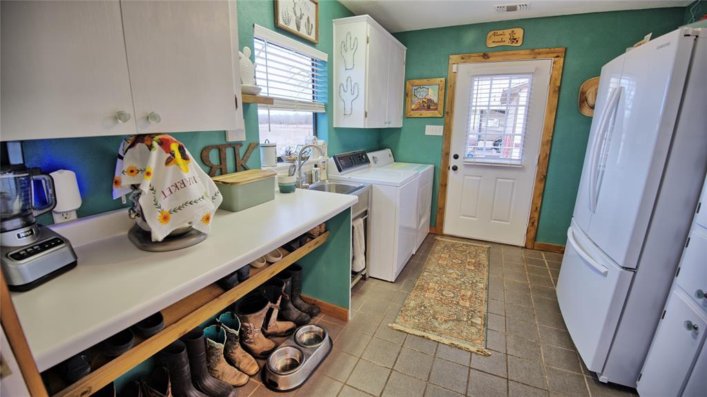 858 Ford Road Bowie, TX 76230 - Photo 15 of 40 a kitchen with stainless steel appliances granite countertop a sink stove and cabinets