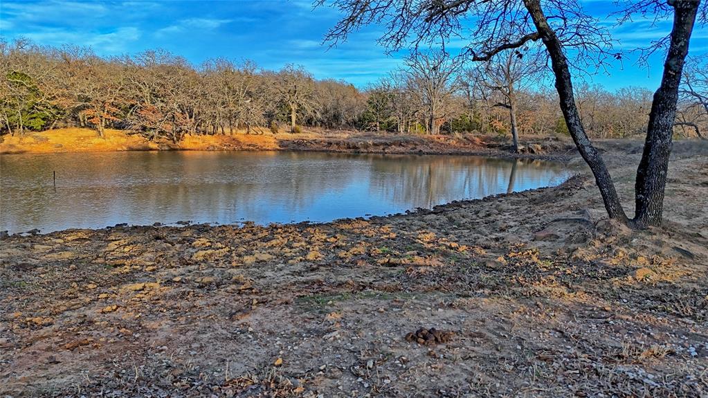 858 Ford Road Bowie, TX 76230 - Photo 18 of 40 a view of a lake with houses in the back