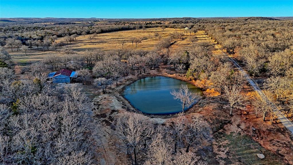 858 Ford Road Bowie, TX 76230 - Photo 26 of 40 a view of a dry yard with wooden fence
