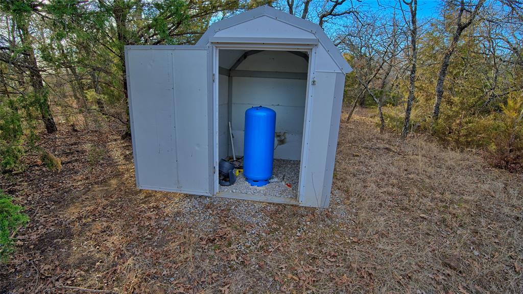 858 Ford Road Bowie, TX 76230 - Photo 28 of 40 a view of a wooden door of the house