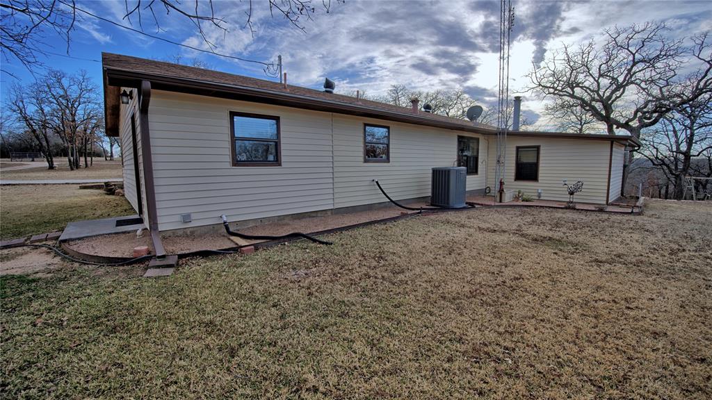 858 Ford Road Bowie, TX 76230 - Photo 30 of 40 a backyard of a house with barbeque oven