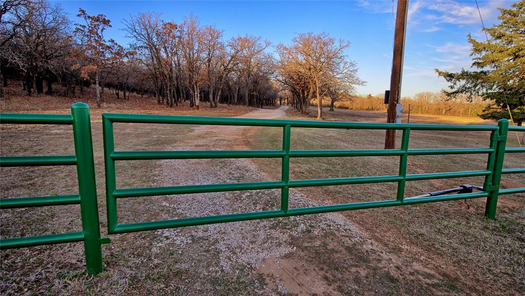 858 Ford Road Bowie, TX 76230 - Photo 3 of 40 a view of a yard with wooden fence