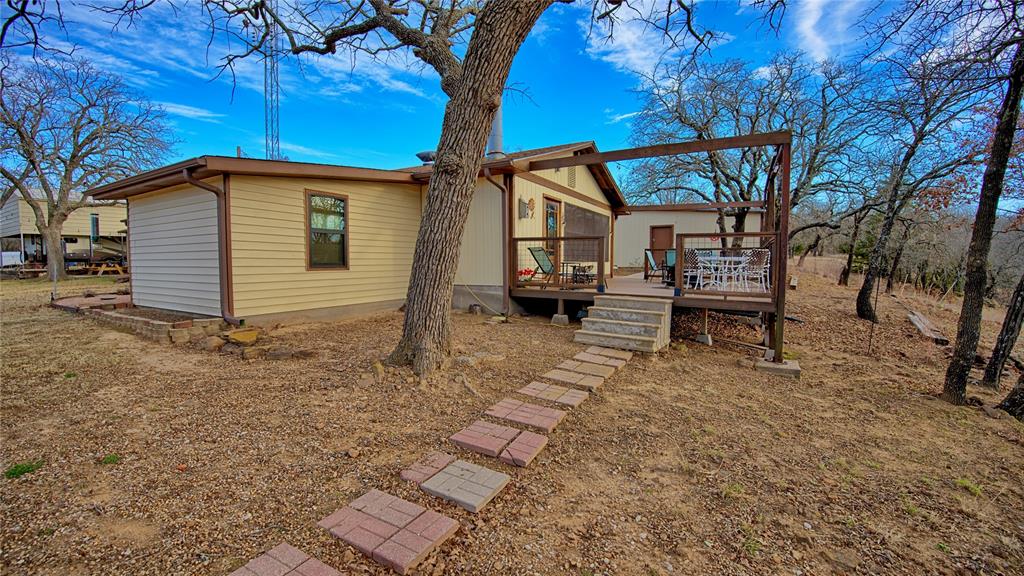 858 Ford Road Bowie, TX 76230 - Photo 31 of 40 a view of a house with backyard and sitting area