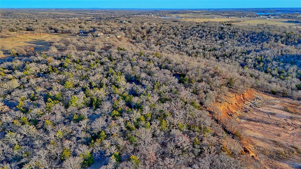 858 Ford Road Bowie, TX 76230 - Photo 40 of 40 a view of a dry yard with wooden floor