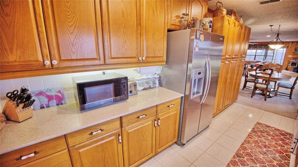 858 Ford Road Bowie, TX 76230 - Photo 10 of 40 a kitchen with cabinets and appliances