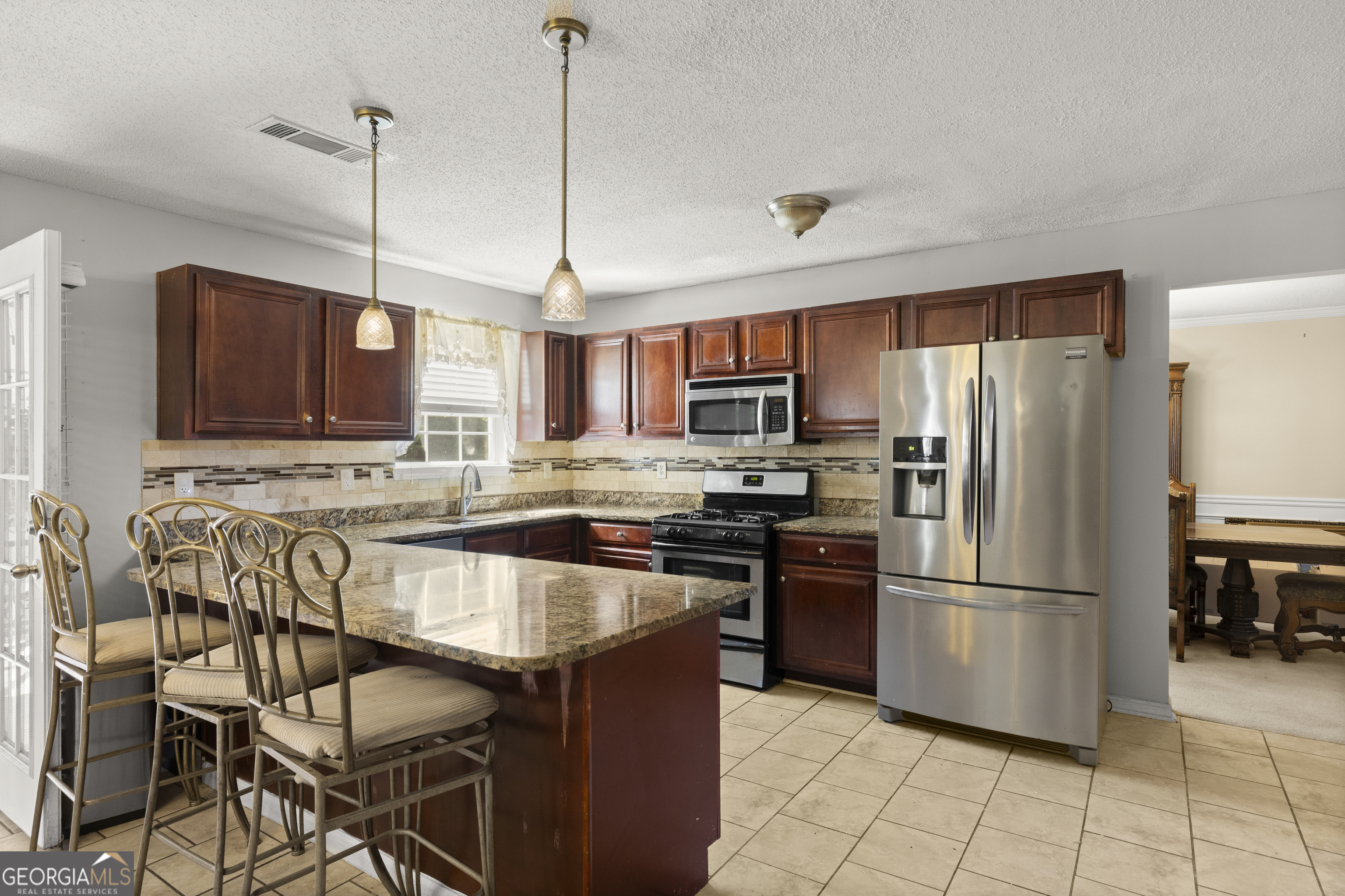 11961 Markham Way Hampton, GA 30228 - Photo 13 of 49 a kitchen with stainless steel appliances granite countertop a refrigerator a stove a sink and a microwave