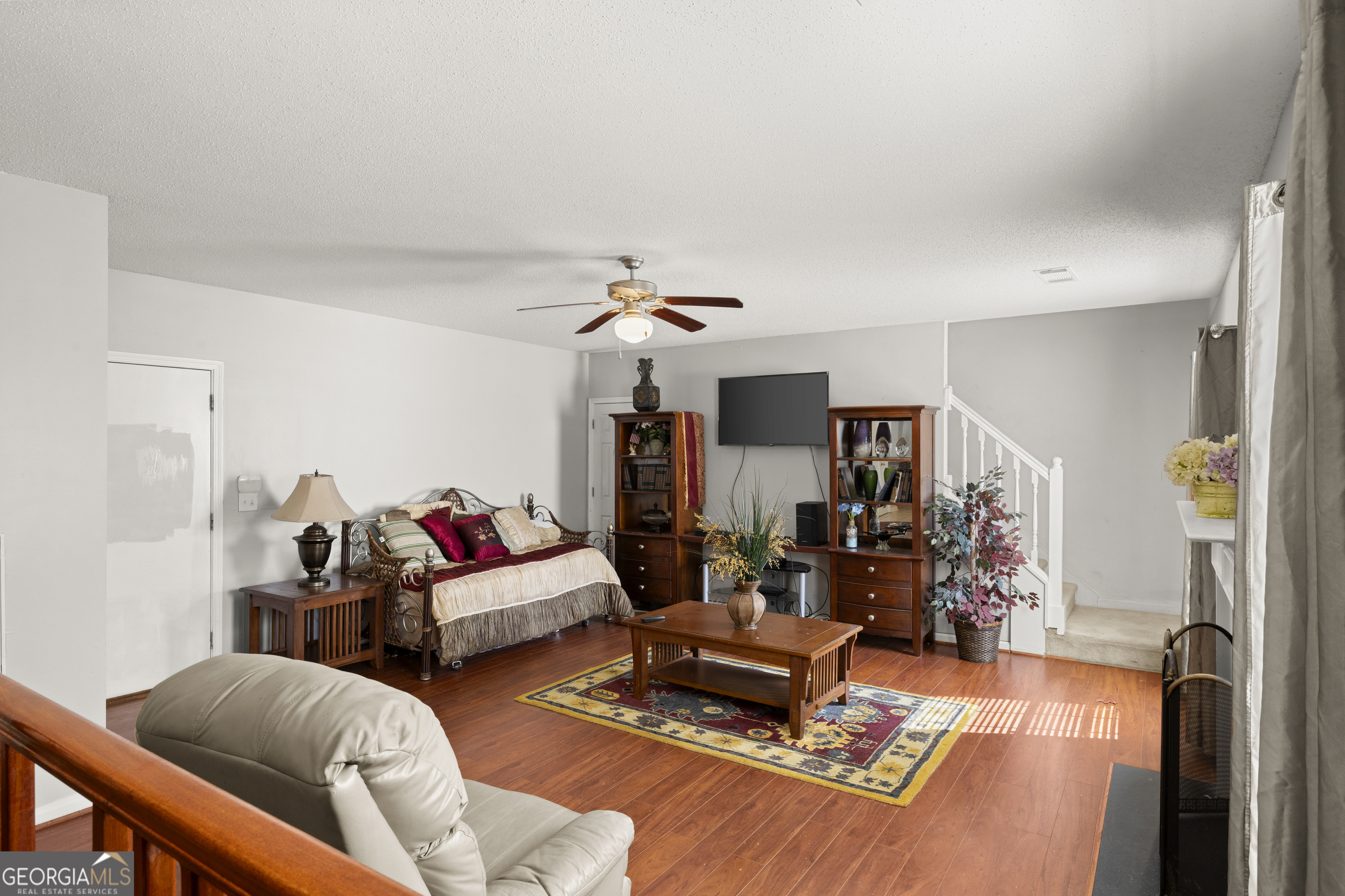 11961 Markham Way Hampton, GA 30228 - Photo 21 of 49 a living room with furniture and a chandelier