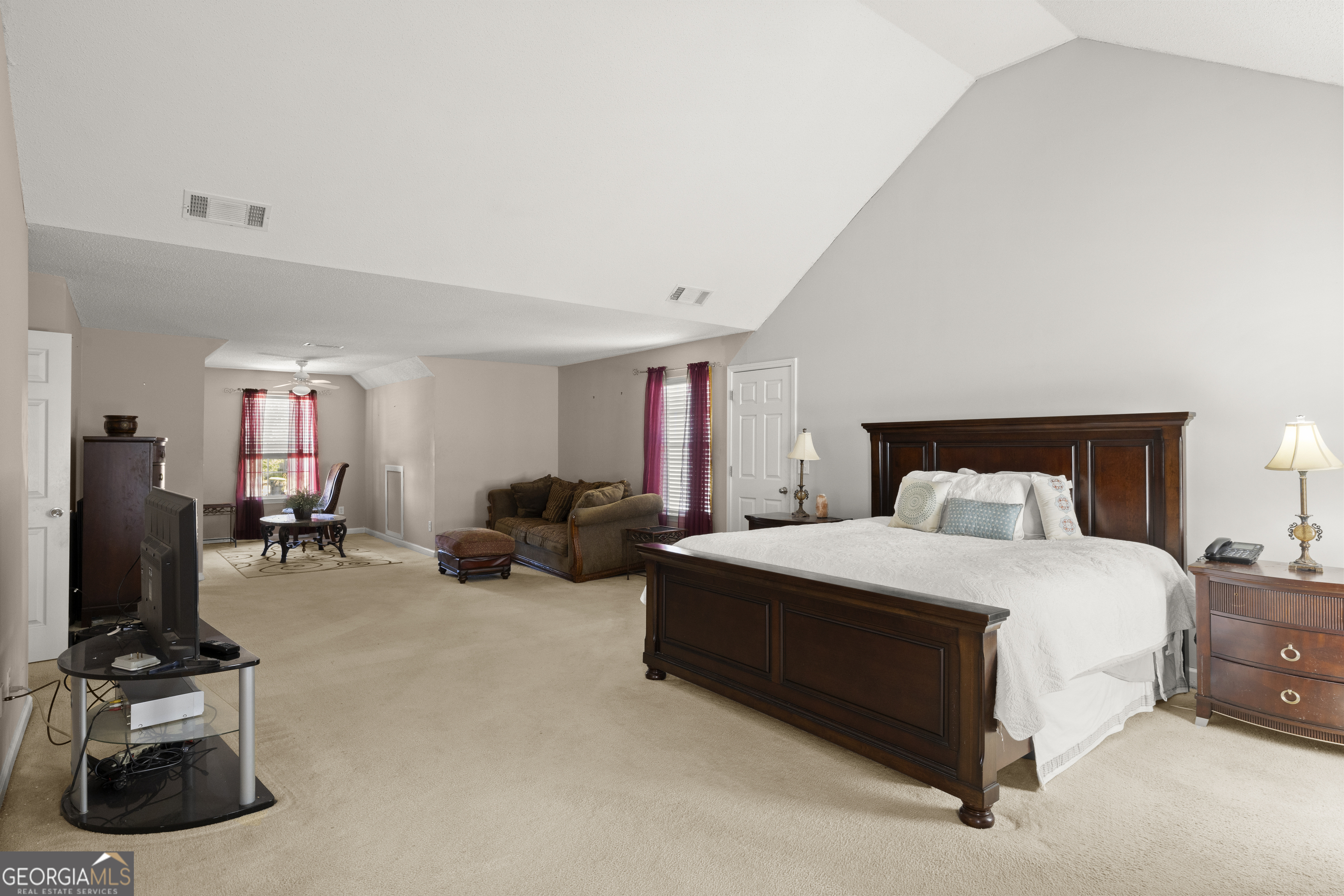 11961 Markham Way Hampton, GA 30228 - Photo 23 of 49 a bedroom with a bed and a flat screen tv