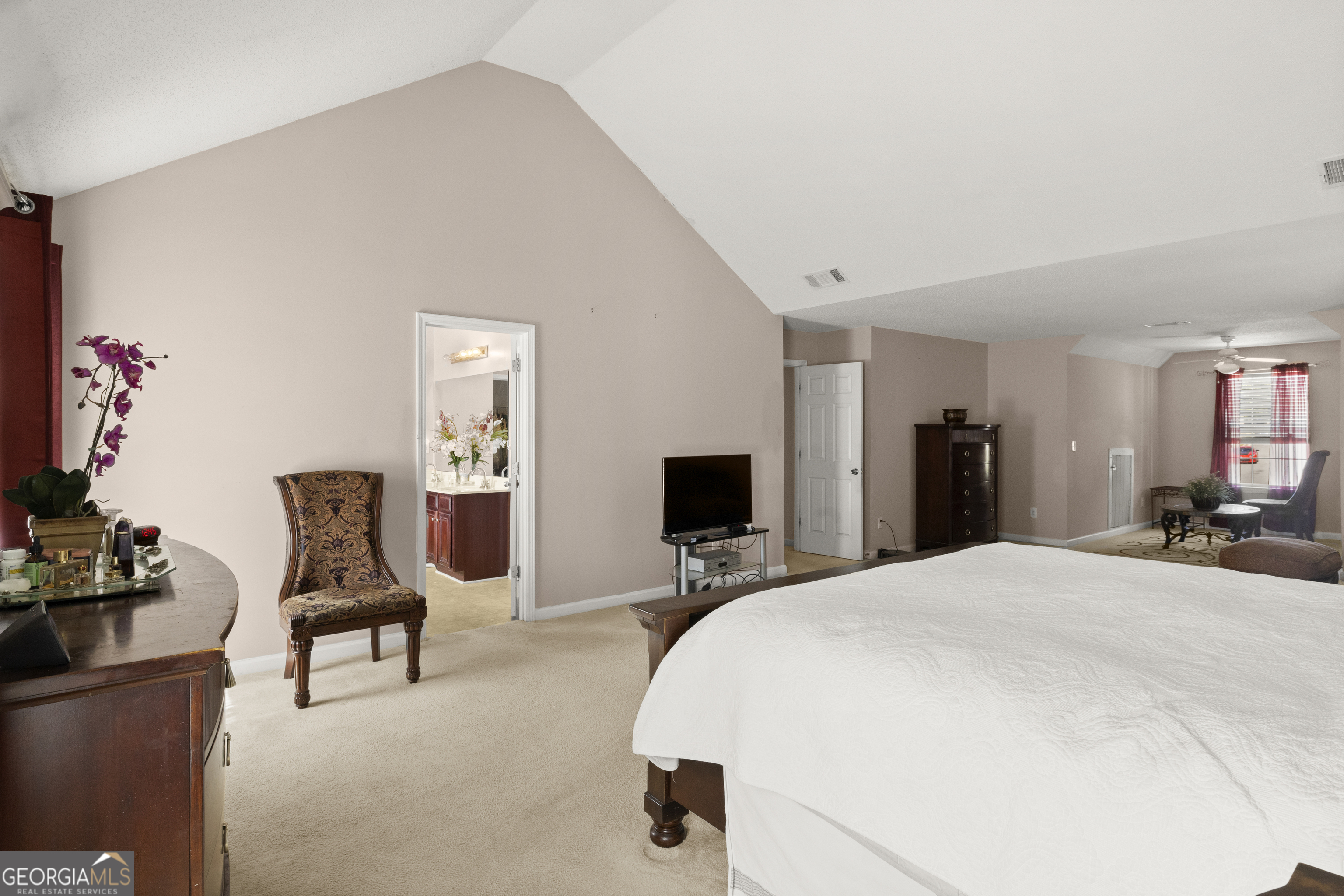 11961 Markham Way Hampton, GA 30228 - Photo 24 of 49 a bedroom with a bed large mirror and desk