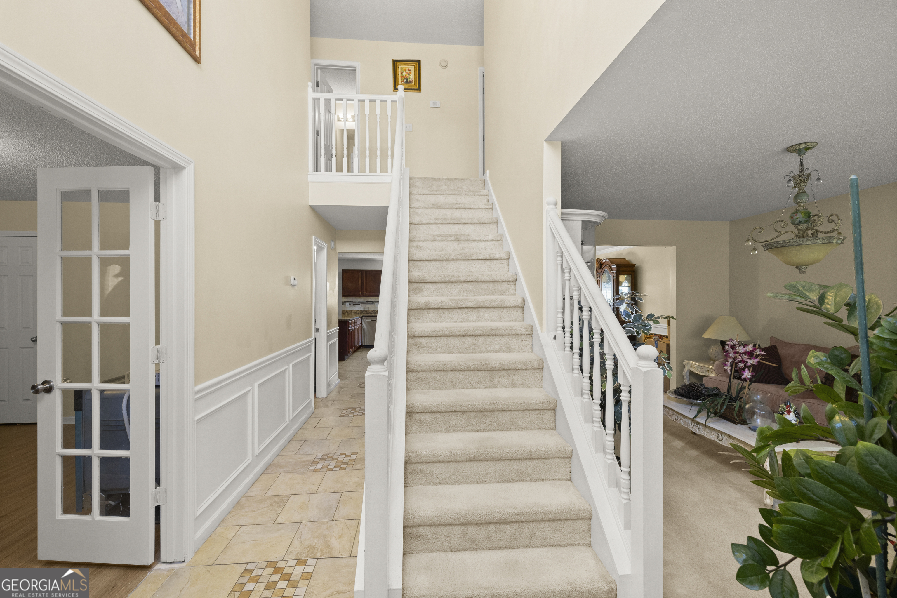 11961 Markham Way Hampton, GA 30228 - Photo 3 of 49 a view of staircase with lots of frames on wall and a window