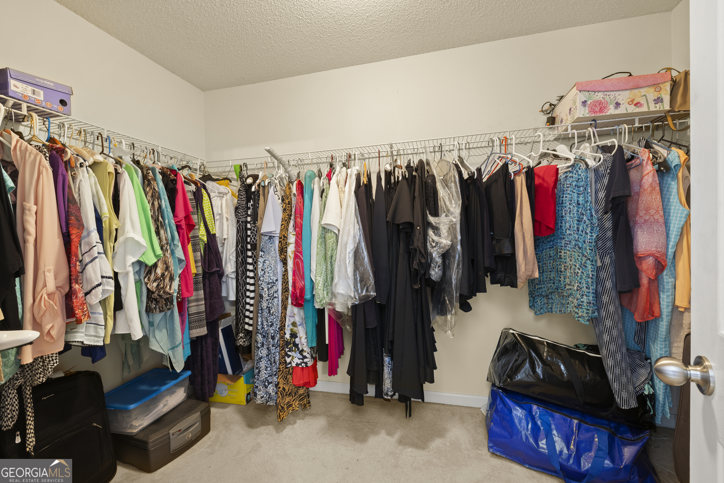 11961 Markham Way Hampton, GA 30228 - Photo 31 of 49 a view of walk in closet with clothes