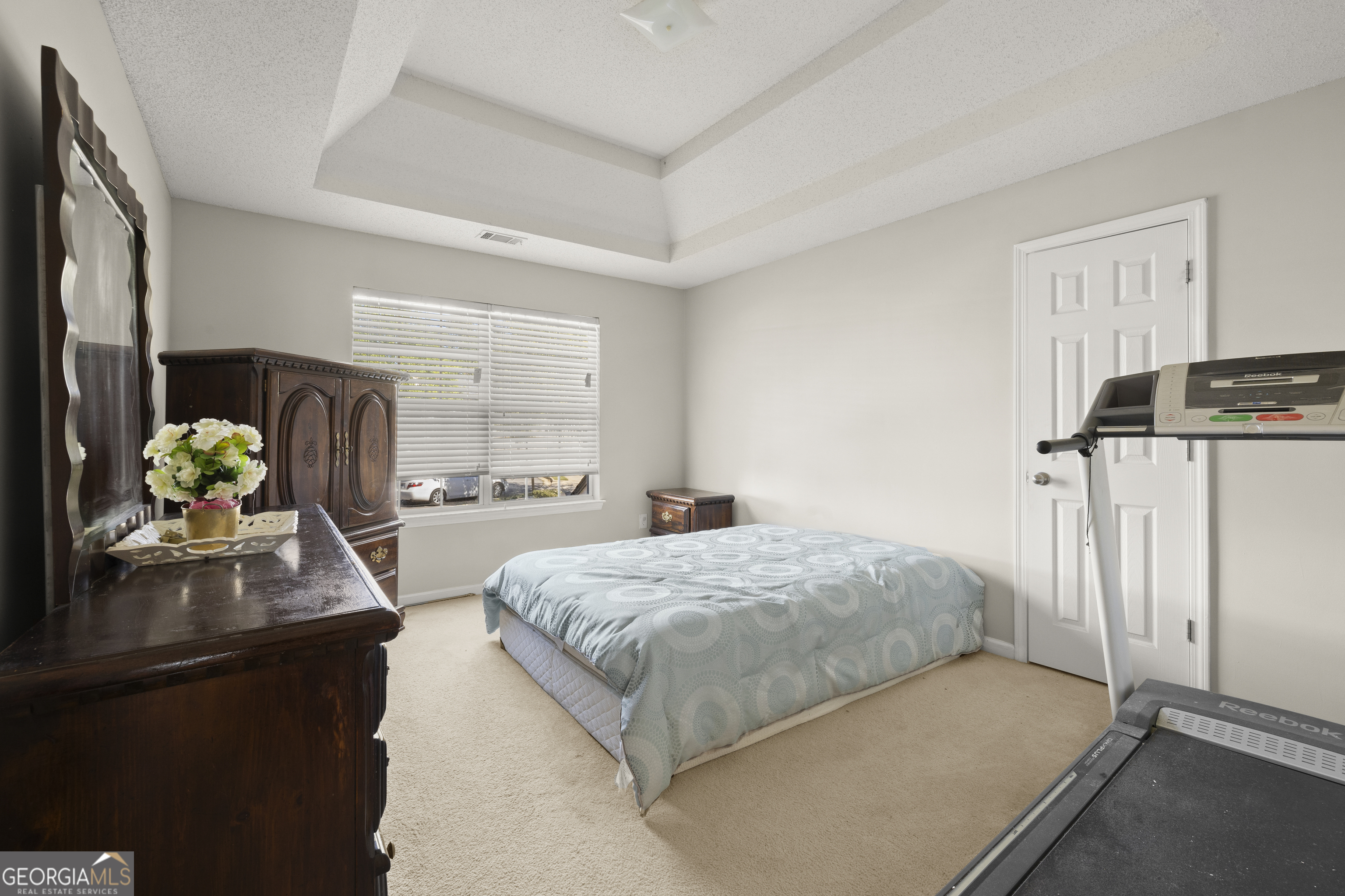 11961 Markham Way Hampton, GA 30228 - Photo 33 of 49 a bedroom with a bed dresser flowerpot and window