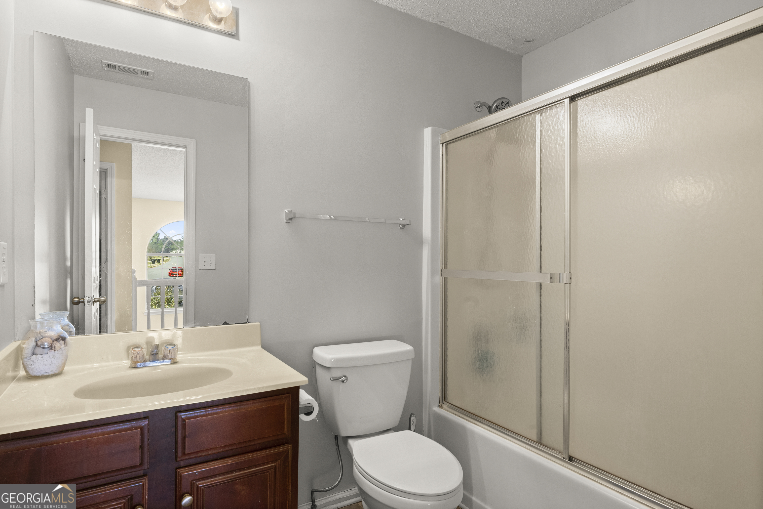 11961 Markham Way Hampton, GA 30228 - Photo 35 of 49 a bathroom with a sink a toilet a mirror and shower