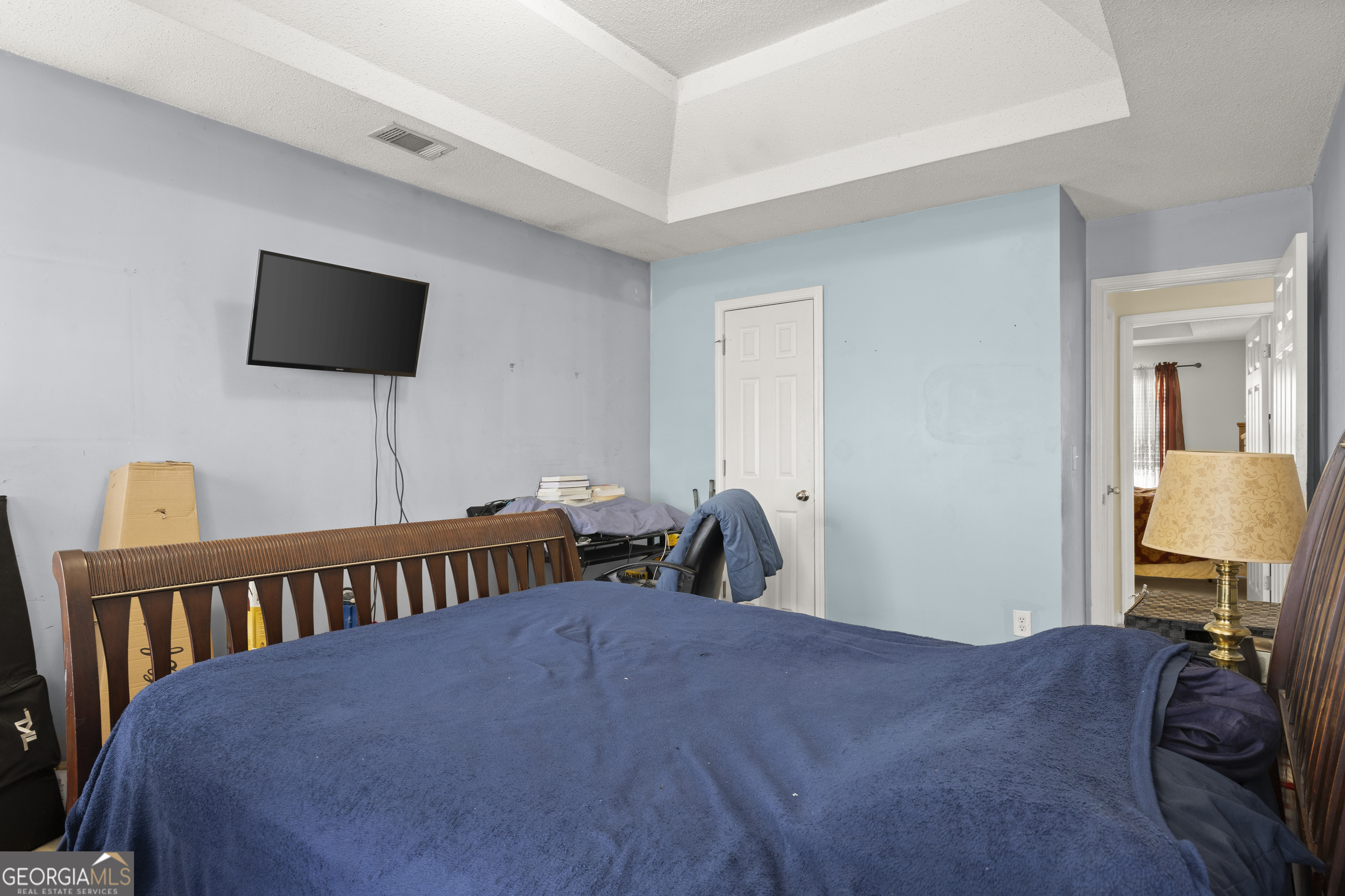 11961 Markham Way Hampton, GA 30228 - Photo 36 of 49 a bedroom with a bed and a flat screen tv