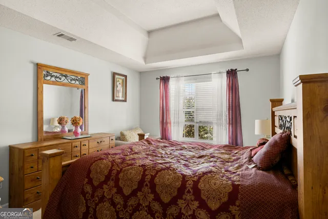 a bedroom with a bed and a dresser