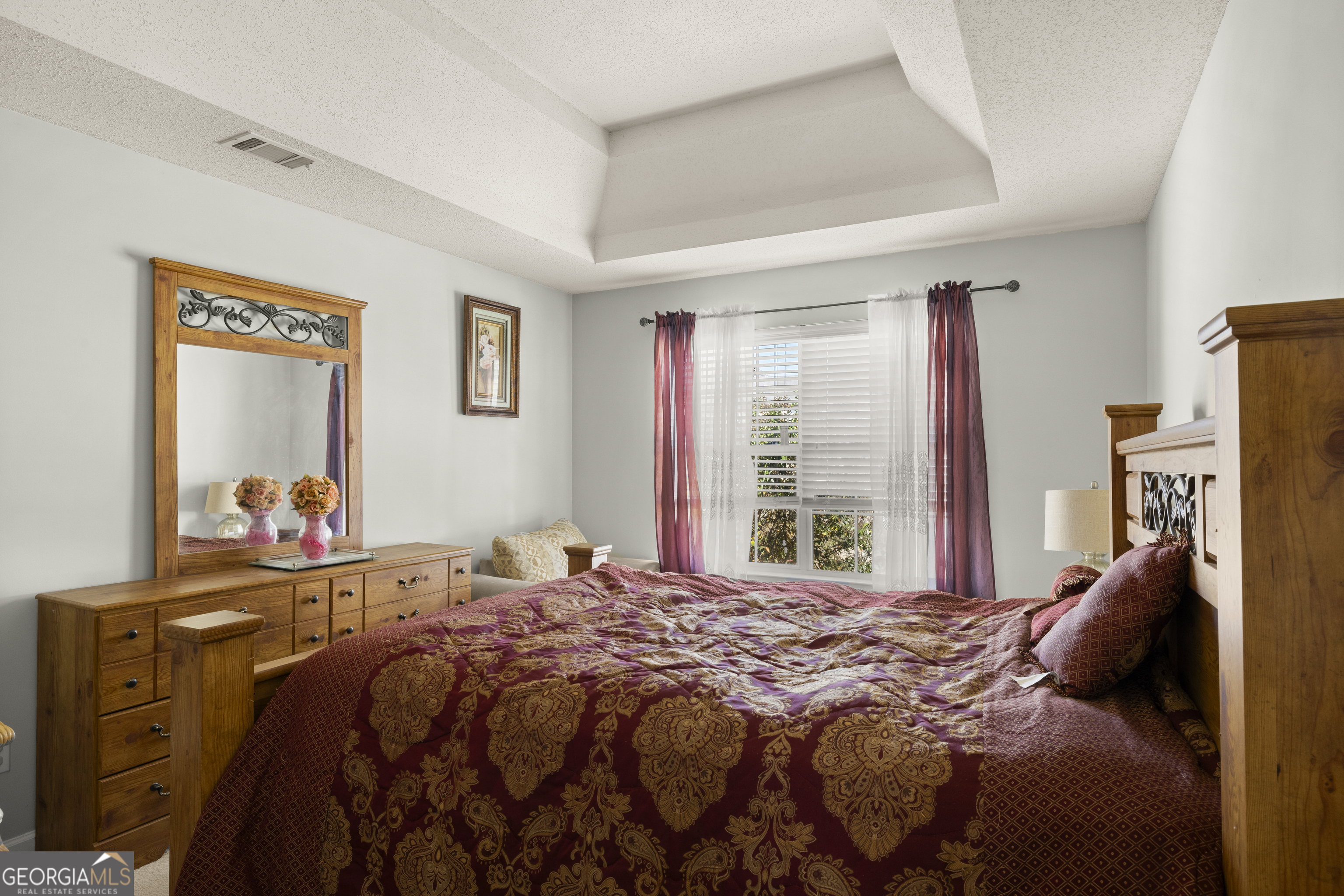 11961 Markham Way Hampton, GA 30228 - Photo 38 of 49 a bedroom with a bed and a dresser