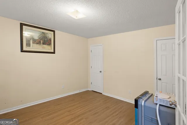 a view of room with wooden floor and window
